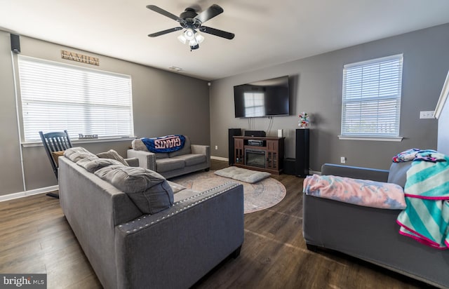 living room with ceiling fan, dark hardwood / wood-style floors, and a wealth of natural light