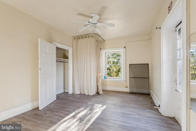 unfurnished bedroom with light hardwood / wood-style flooring and ceiling fan