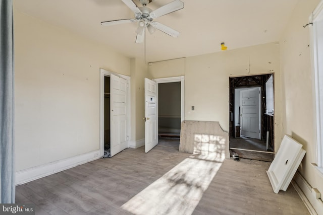 unfurnished bedroom with ceiling fan and light wood-type flooring