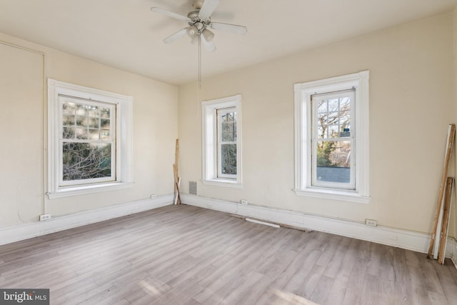 spare room featuring light hardwood / wood-style flooring and ceiling fan