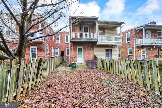 back of house with a balcony