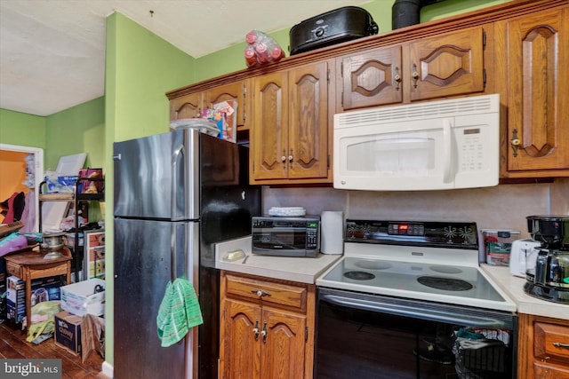 kitchen featuring stainless steel fridge and electric range