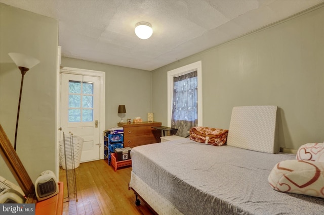 bedroom featuring a textured ceiling and light wood-type flooring