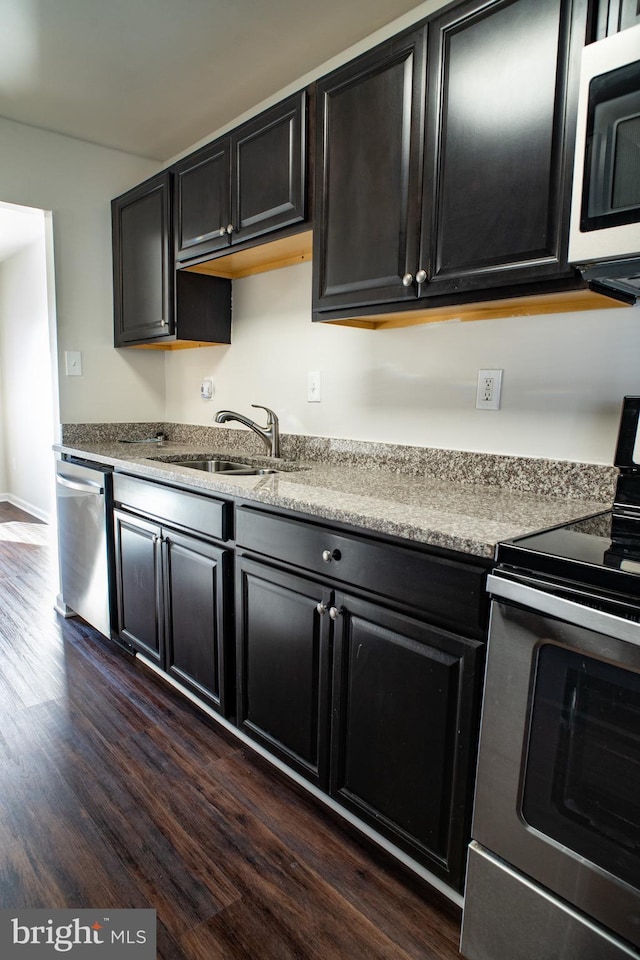 kitchen with sink, dark hardwood / wood-style floors, and appliances with stainless steel finishes