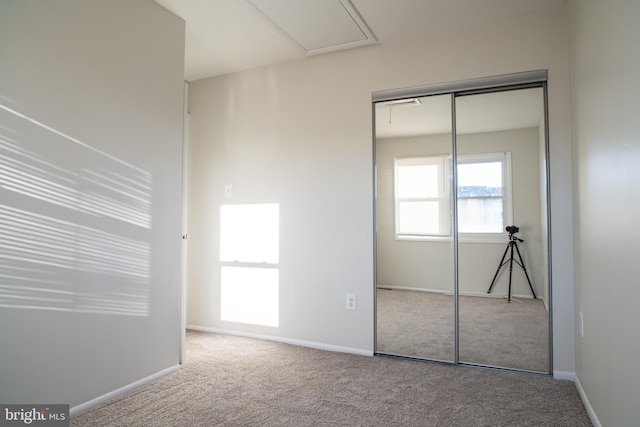 unfurnished bedroom featuring a closet and carpet