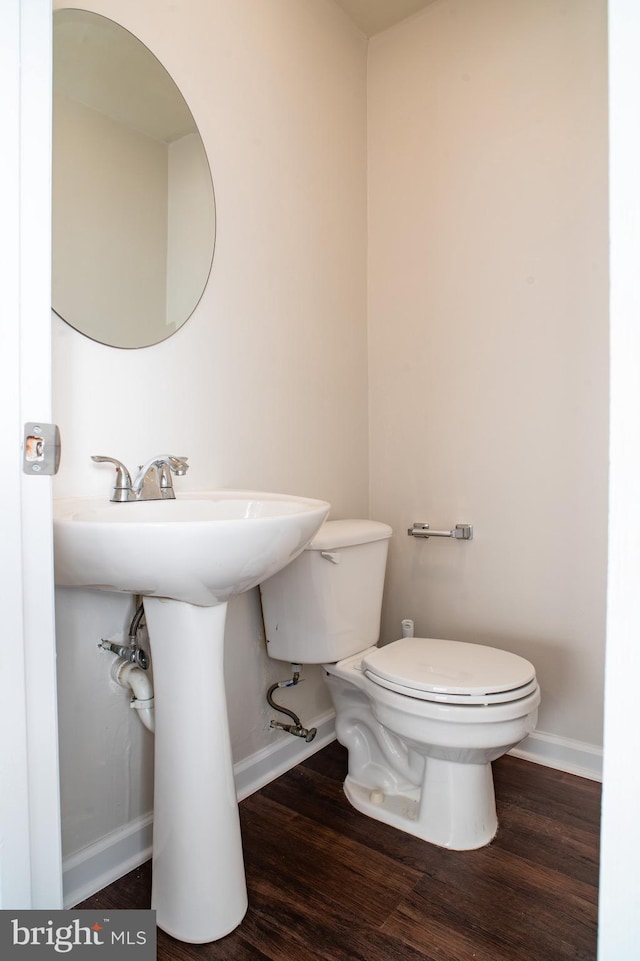 bathroom featuring hardwood / wood-style floors and toilet