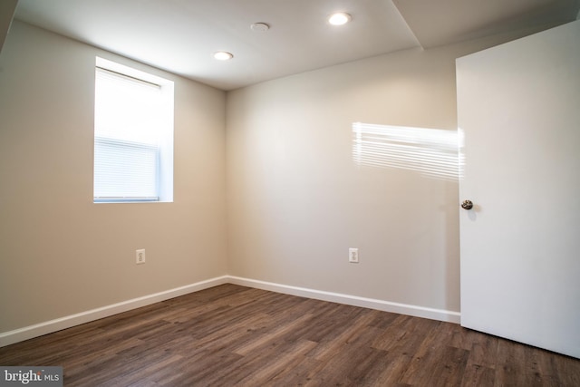 empty room with dark hardwood / wood-style flooring