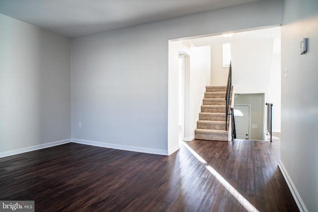 empty room featuring dark wood-type flooring