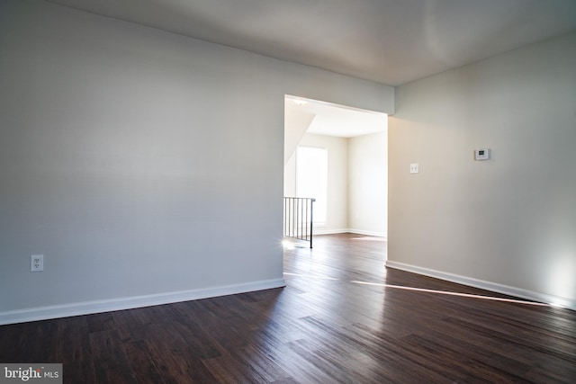 empty room featuring dark wood-type flooring