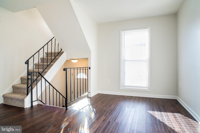 stairway with hardwood / wood-style floors and plenty of natural light