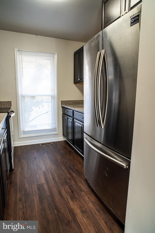 kitchen with dark wood-type flooring and stainless steel appliances