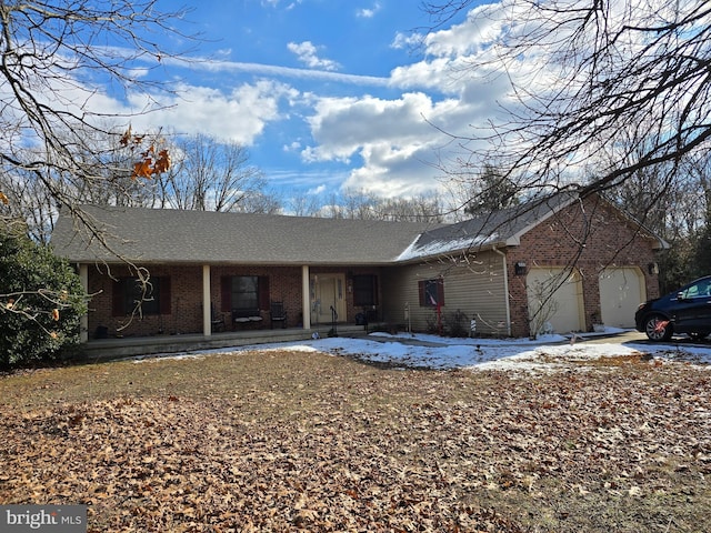 single story home featuring a garage and covered porch