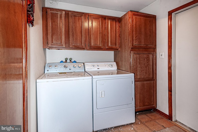 clothes washing area featuring cabinets and independent washer and dryer