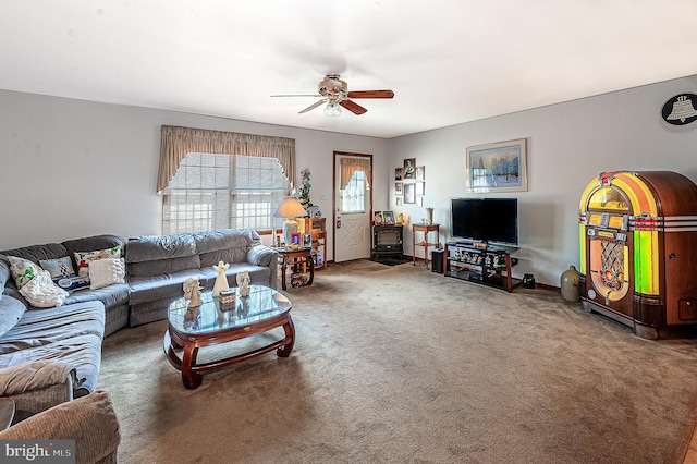 carpeted living room featuring ceiling fan