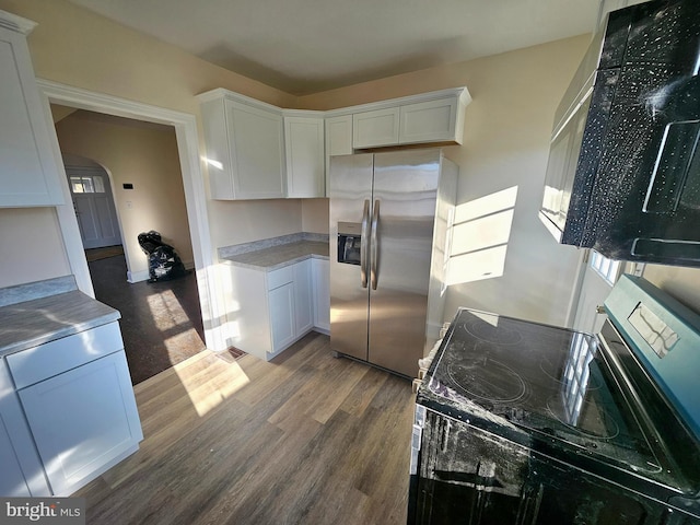 kitchen featuring stainless steel appliances, dark hardwood / wood-style floors, and white cabinets