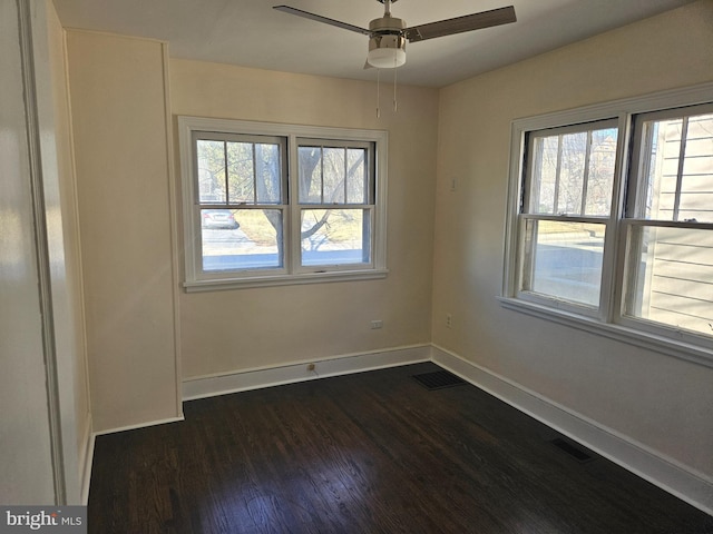 spare room featuring ceiling fan and dark hardwood / wood-style floors