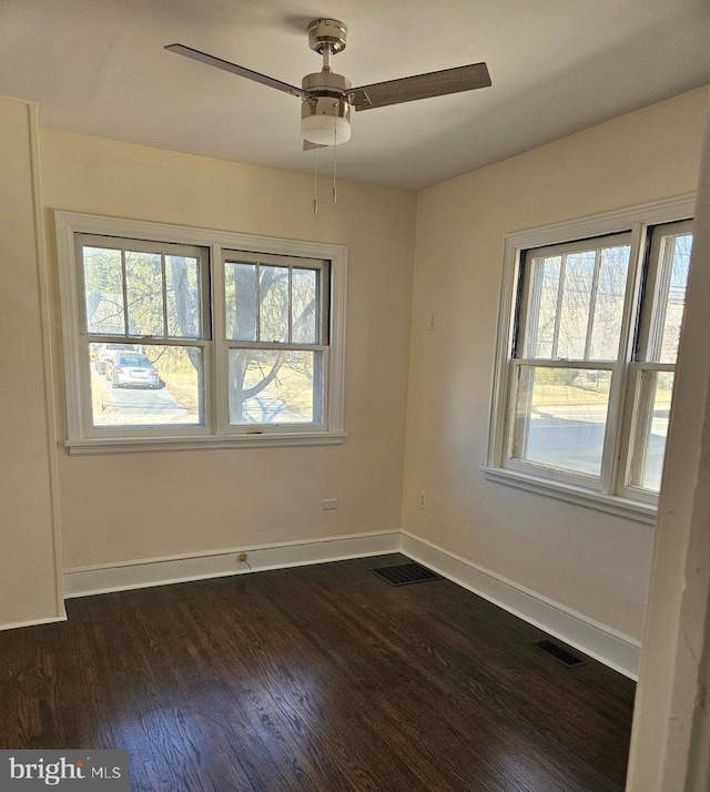 spare room featuring dark hardwood / wood-style flooring and ceiling fan