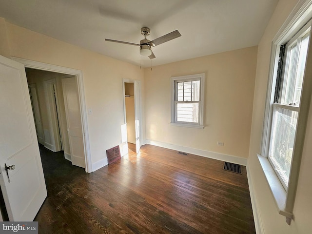 unfurnished bedroom with dark wood-type flooring and ceiling fan