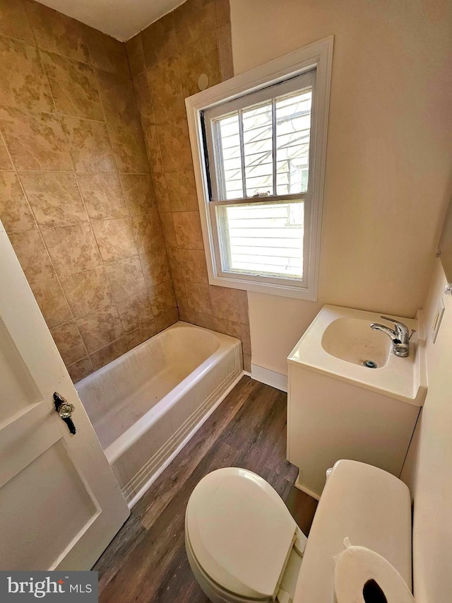 bathroom with sink, hardwood / wood-style flooring, and toilet