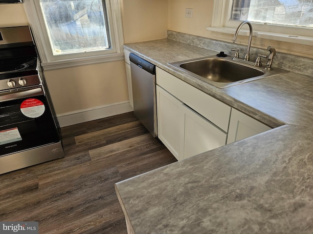 kitchen with white cabinetry, appliances with stainless steel finishes, sink, and dark hardwood / wood-style floors