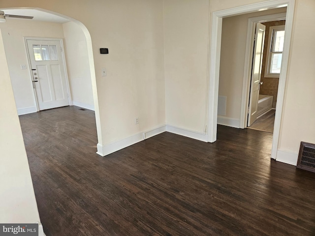 unfurnished room featuring ceiling fan and dark hardwood / wood-style floors