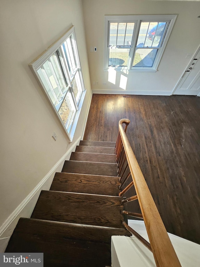 stairs featuring hardwood / wood-style floors