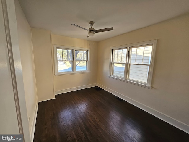 empty room with dark wood-type flooring and ceiling fan