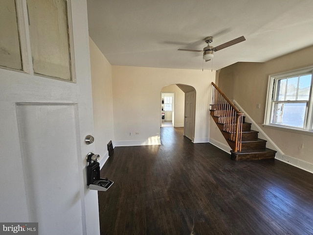 spare room with ceiling fan, a healthy amount of sunlight, and dark hardwood / wood-style floors