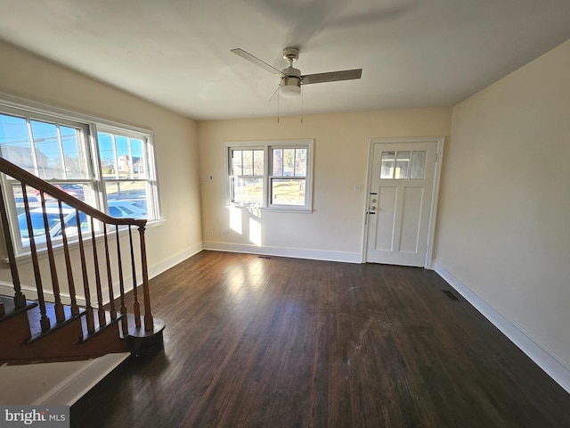 entryway with ceiling fan, a healthy amount of sunlight, and dark hardwood / wood-style flooring