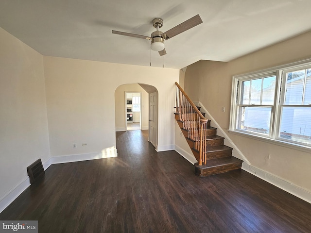 interior space with dark wood-type flooring and ceiling fan