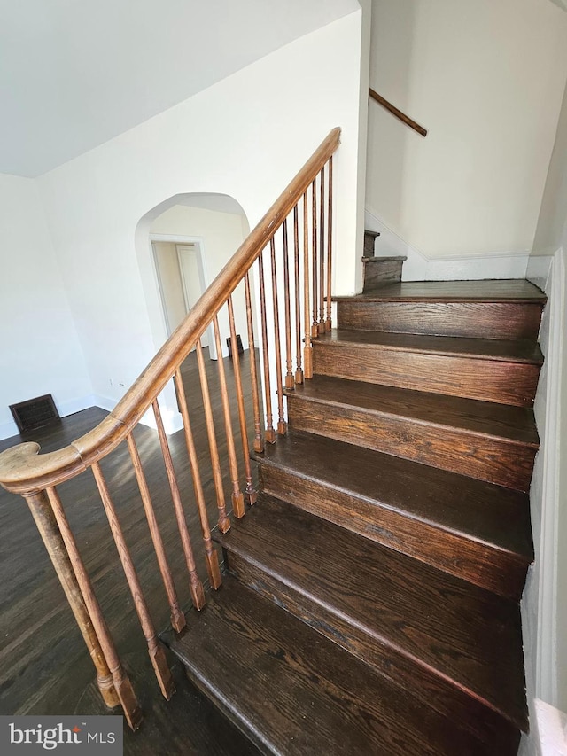 stairs featuring hardwood / wood-style floors