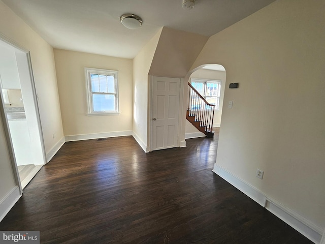 additional living space with dark hardwood / wood-style floors and vaulted ceiling