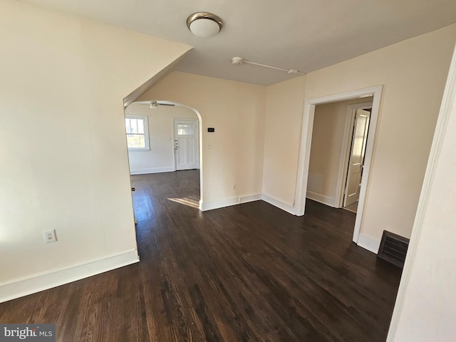 spare room with dark wood-type flooring