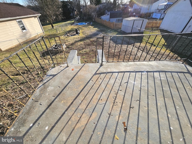 wooden terrace with a storage shed