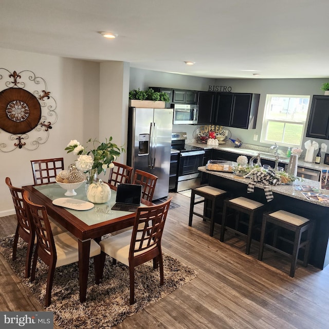 dining space with wood-type flooring