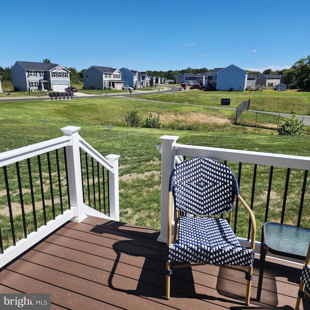 wooden deck featuring a yard