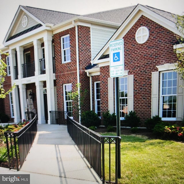 greek revival inspired property featuring a front lawn