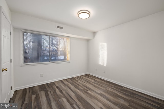 spare room featuring dark hardwood / wood-style floors