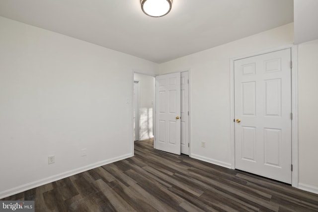 unfurnished bedroom featuring dark wood-type flooring