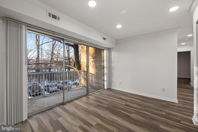 spare room featuring ornamental molding and wood-type flooring