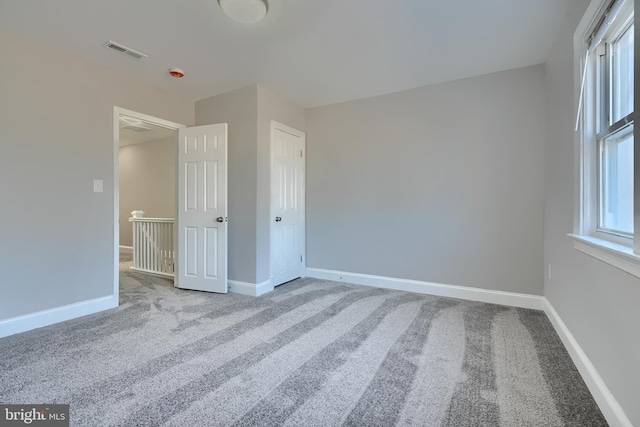 unfurnished bedroom featuring carpet