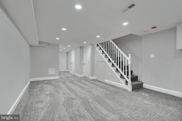 basement featuring light carpet