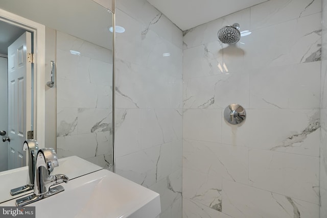 bathroom featuring sink and tiled shower