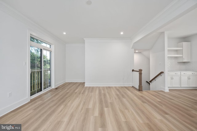 unfurnished living room featuring ornamental molding and light hardwood / wood-style floors