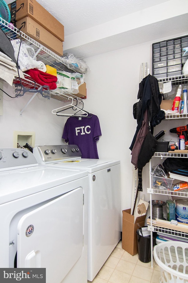 laundry room featuring light tile patterned flooring and washing machine and clothes dryer