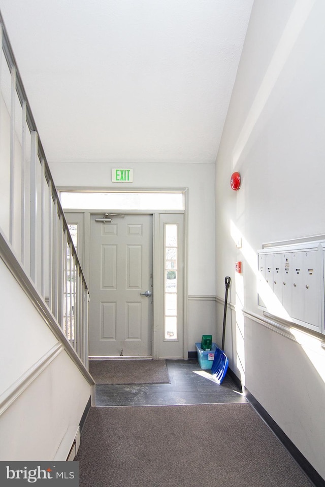 entryway with a baseboard heating unit and mail boxes