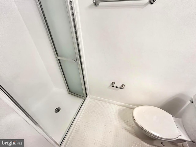 full bath featuring a shower stall, toilet, and tile patterned floors