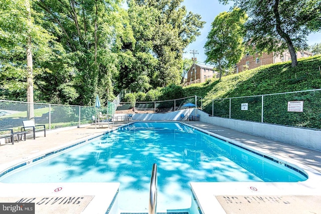 pool featuring fence and a patio