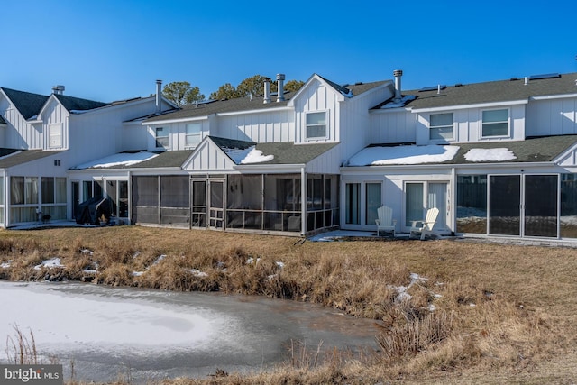 rear view of house featuring a sunroom