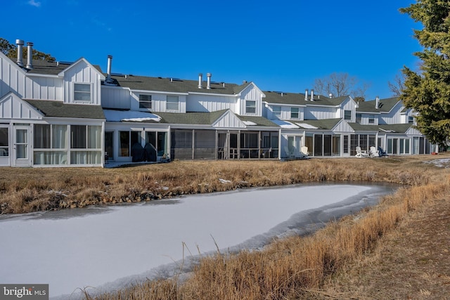 back of house featuring a water view